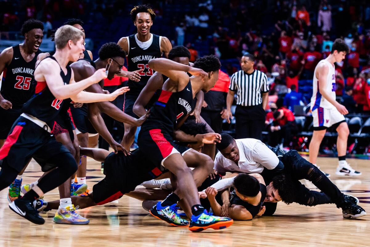 The Panther’s storm the court in a dog pile after time expires in the 6A state final between Duncanville and Austin Westlake 66-53 in the 6A state final at the Alamodome in San Antonio Texas, on March 13, 2021. (Photo by Matt Smith. Special to the Star-Telegram).