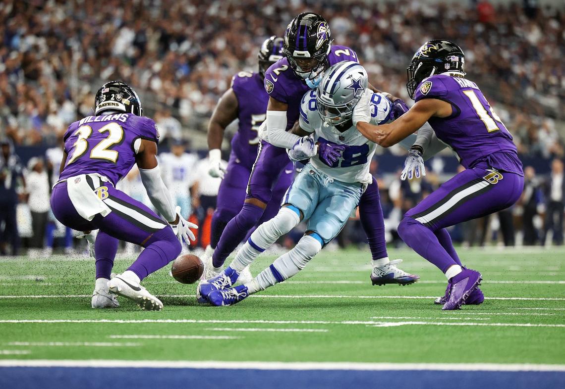 Baltimore Ravens free safety Marcus Wiliams (32) scoops up a fumble by Dallas Cowboys wide receiver CeeDee Lamb (88) on Sunday, Sept. 22, 2024 at AT&T Stadium in Arlington.