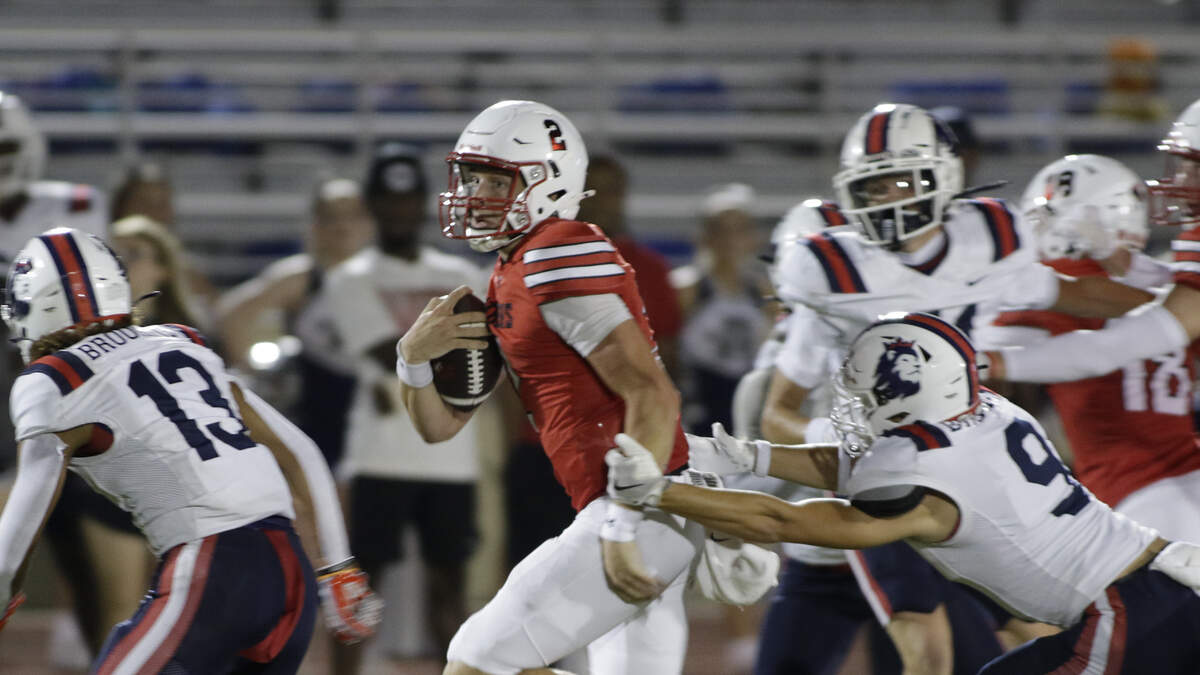 Colleyville Heritage’s Bodey Weaver looks for running room during a Class 5A game against Richland at Mustang-Panther Stadium on Friday, Sept. 5, 2025.