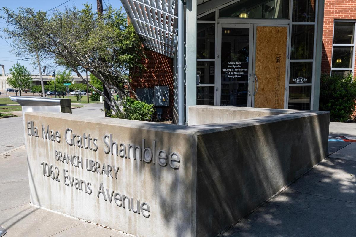 One of the doors is boarded up using a wood plank after the door was vandalized at the Ella Mae Gratts Shamblee Branch Library in Fort Worth on Tuesday, April 15, 2025.
