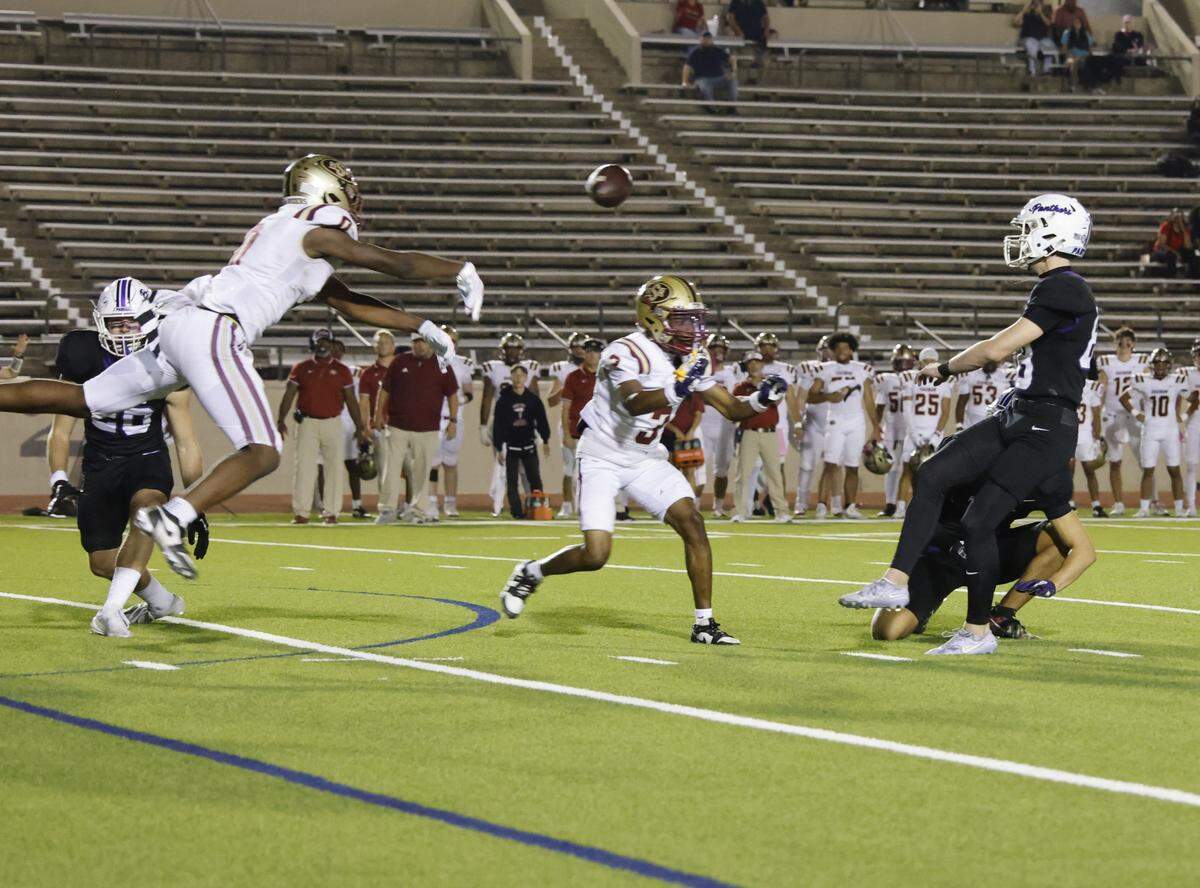 Saginaw defensive end Isaac Bukasa (0) blocks the possible game winning field goal attempt of Paschal kicker Joshua Wedemeyer (88) during the second half of a UIL football game between Saginaw and Paschal at Farrington Field in Fort Worth, Texas, Thursday, October, 16, 2025.