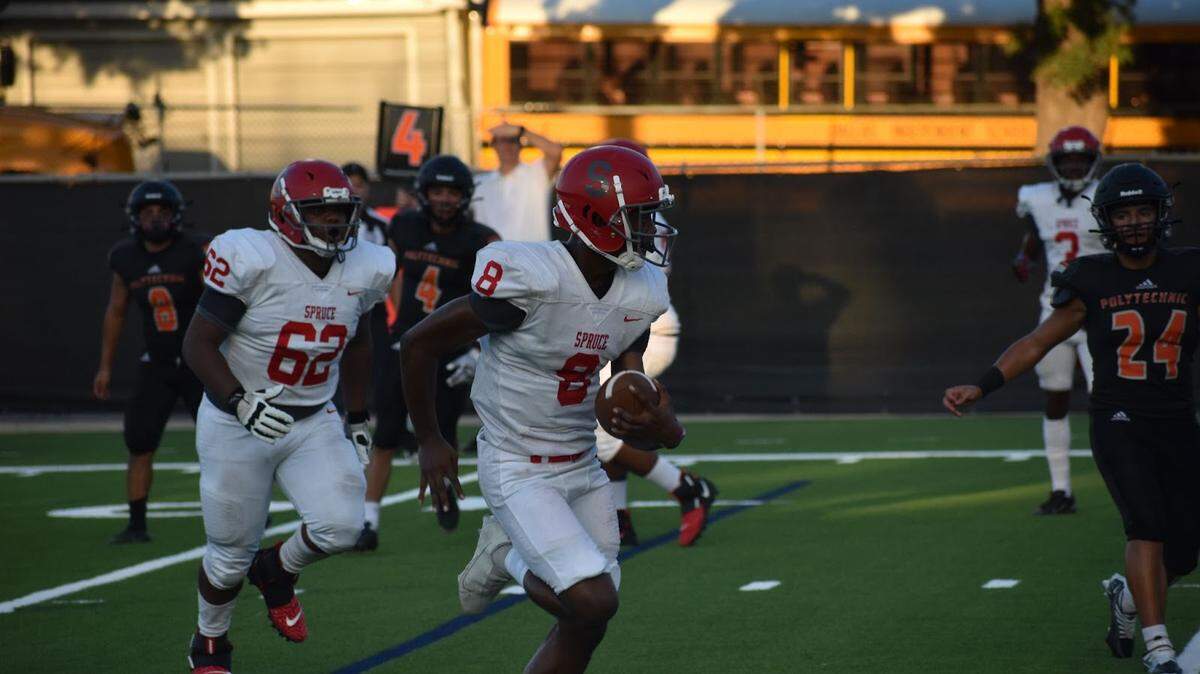 Spruce’s Kelvin Jones (8) runs the ball for his second touchdown against Poly on Friday.