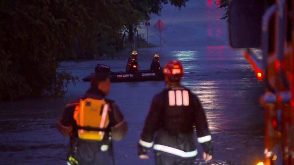 Arlington firefighters search floodwaters covering Webb Ferrell Road and Hanrahan Avenue in southern Arlington, near Webb Community Park