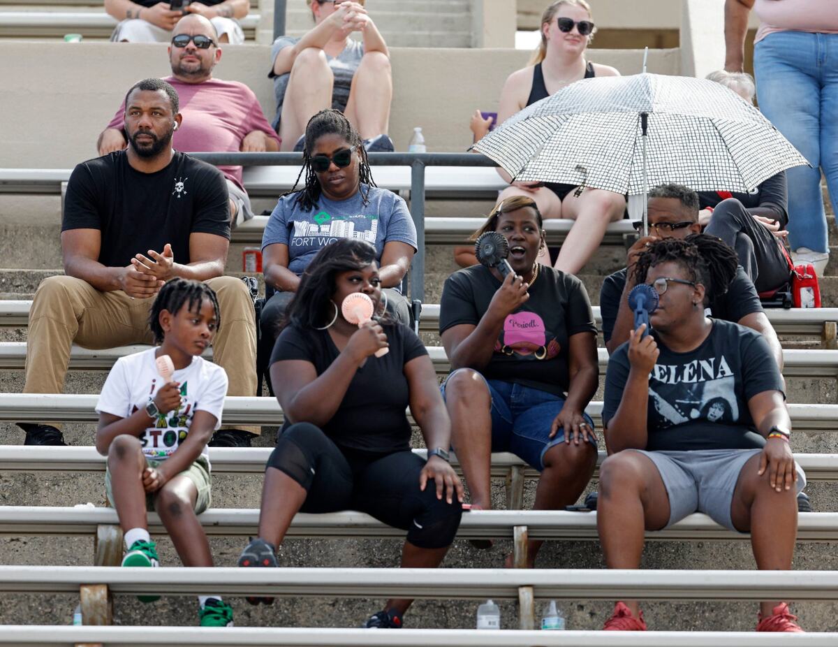 Saginaw fans attempt to avoid the 94 degree weather during a UIL football game at Farrington Field in Fort Worth Saturday, Sept. 14, 2024.
