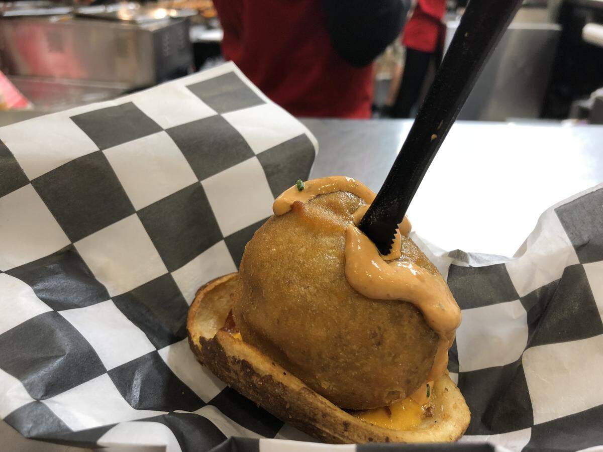 The Deep Fried Skillet Potato Melt in a Boat combines potatoes with breakfast sausage crumbles and then packs it all around a mini Babybel cheese. The whole thing is then fried and served inside a halved, carved-out potato boat.