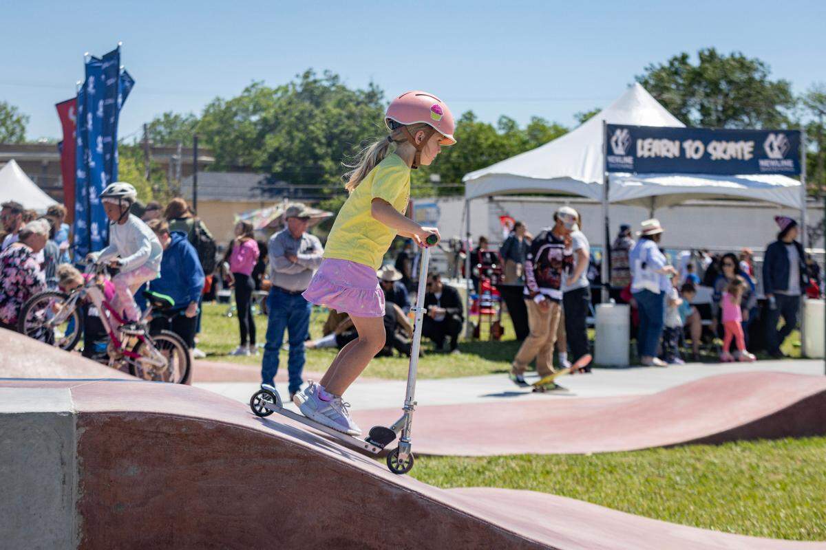 Aveline Bruce, 7, rides her scooter at the Dickies Skate Plaza in Fire Station Park on Saturday, April 29, 2023 in Fort Worth. The opening day event featured live music, food trucks and local vendors like Magnolia Skate Shop.