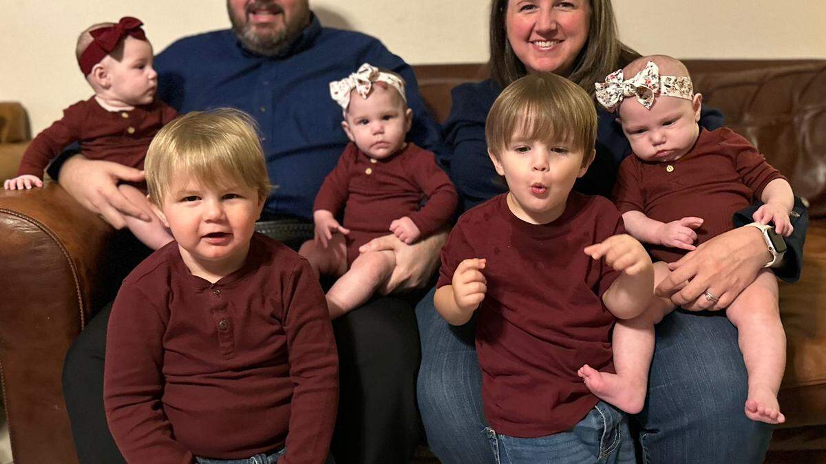 After a decade of believing they couldn’t have children, Paul and Sarah Burkett used fertility treatments and had five children in two years. Pictured with them are their children, twins Paul and David (front), along with triplets Hannah (left), Emma (middle) and Olivia.