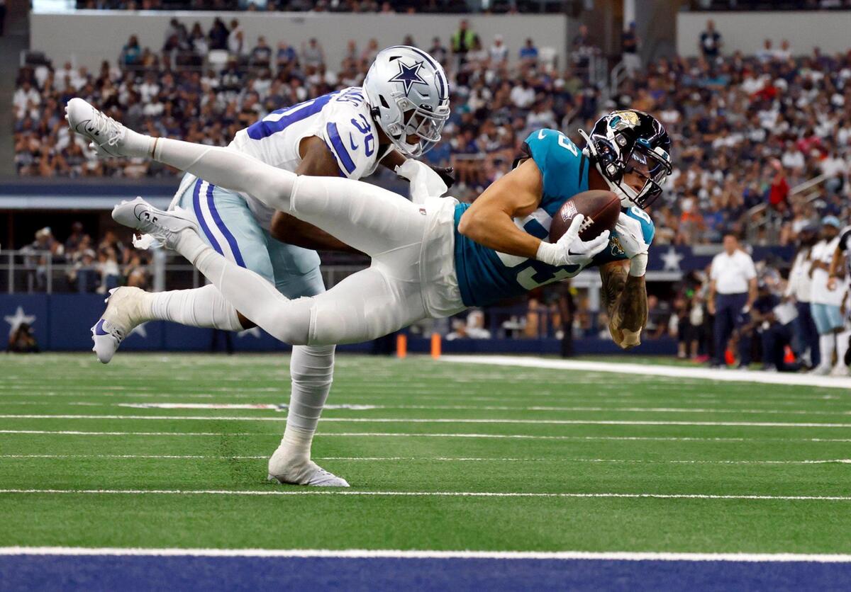Jacksonville Jaguars wide receiver Seth Williams catches the ball while being defended by Dallas Cowboys safety Juanyeh Thomas during a preseason game on Saturday, August 12, 2023, at AT&T Stadium in Arlington.