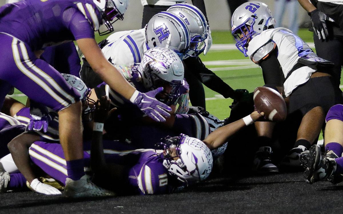 Alvarado’s Cardea Collier shows the ball to the referee after emerging from a pile for a touchdown during a UIL football playoff game at Crowley ISD Multi Purpose Stadium on Friday November 8, 2024.