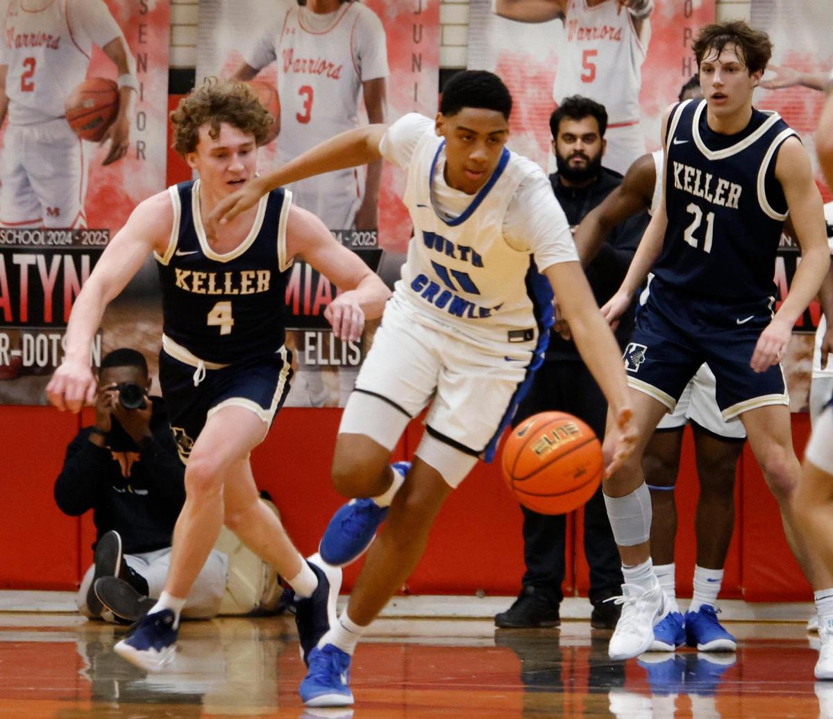 North Crowley forward Trey Hall (11) drives the ball down court in front of Keller guard Parker Viers (4) and point guard Cash Erdmann (21) during the first half of the UIL 6A Region I Bi-District playoff game at Martin High School in Arlington, Texas, Monday, Feb. 17, 2025.