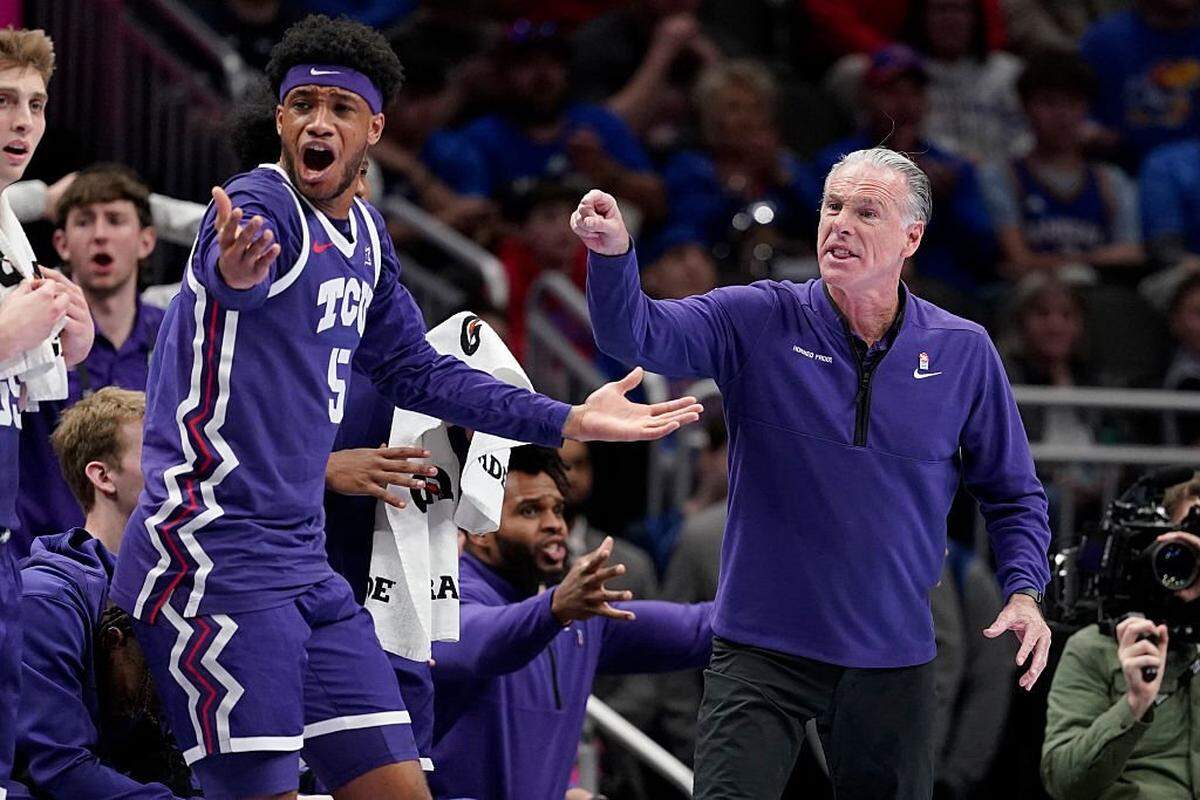 KANSAS CITY, MISSOURI - MARCH 12: Micah Robinson #5 of the TCU Horned Frogs and Head coach Jamie Dixon of the TCU Horned Frogs react to a call against the Kansas Jayhawks in the first half during the quarterfinals of the Big 12 Tournament at T-Mobile Center on March 12, 2026 in Kansas City, Missouri. (Photo by Ed Zurga/Getty Images)