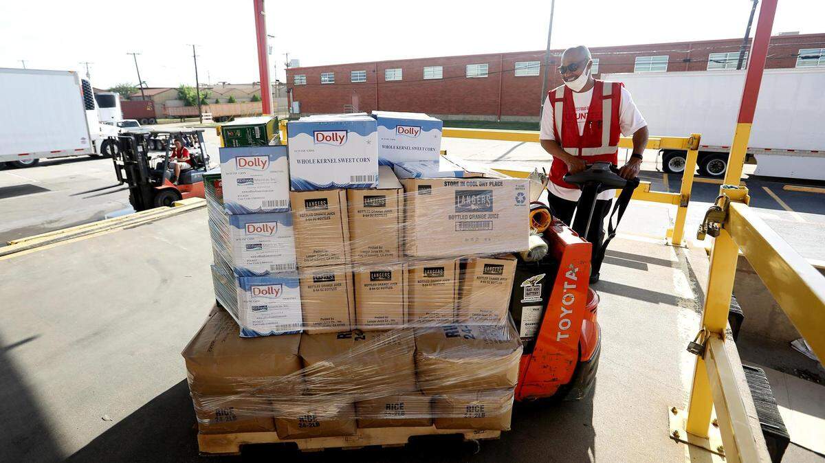 Tarrant Area Food Bank employee Michael Kelly brings out a pallet of food while working to load distribution trucks on May 27, 2021, in Fort Worth. Now, without the support of two major federal funding programs, the food bank is calling for a strong Farm Bill that would strengthen other federal food assistance programs.