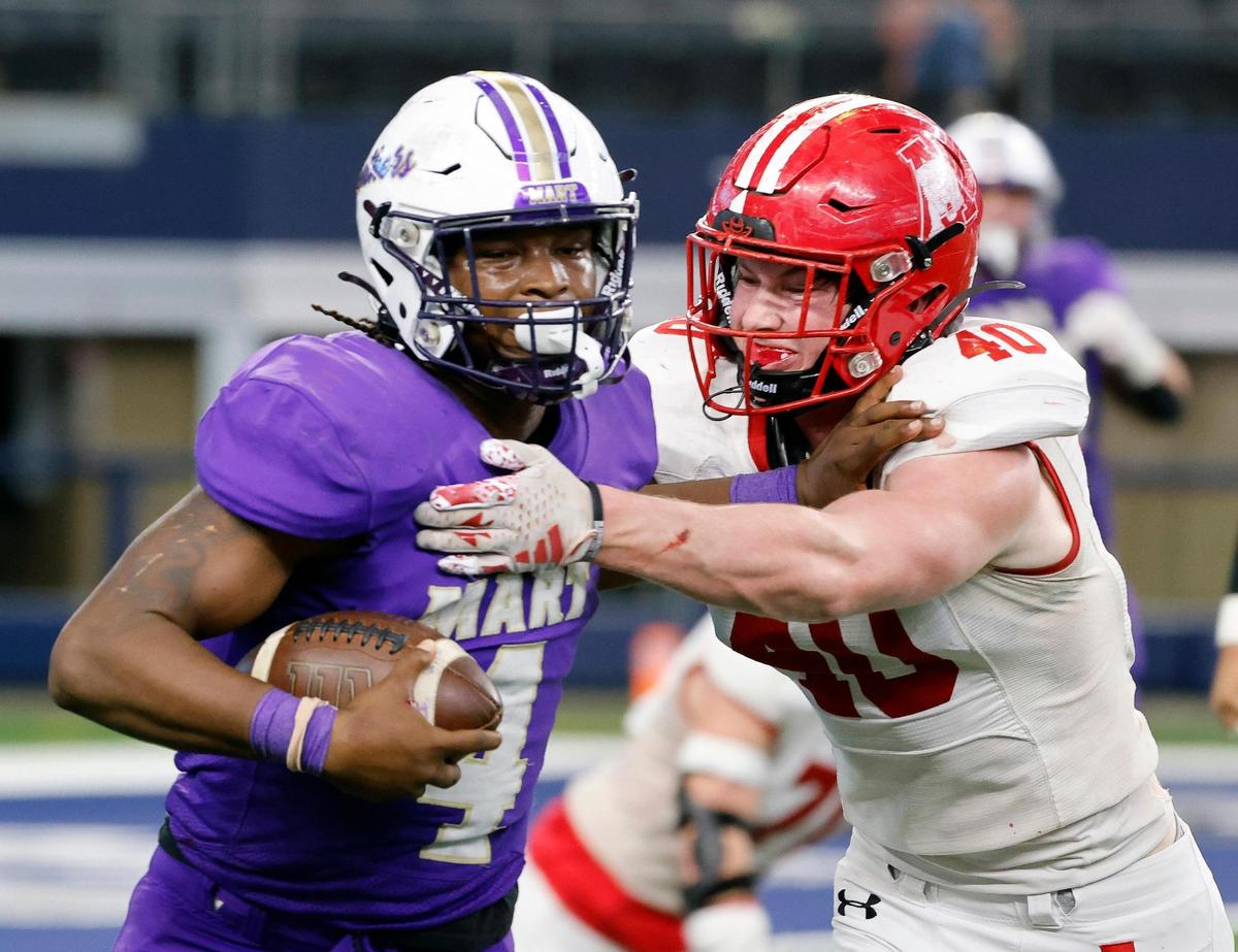 Mart quarterback De’Montrel Medlock runs away from Albany corner back Tyler Chapman during the first half of the UIL Conference 2A Division 2 state championship football game at AT&T Stadium in Arlington, Texas, Thursday, Dec. 14, 2023.