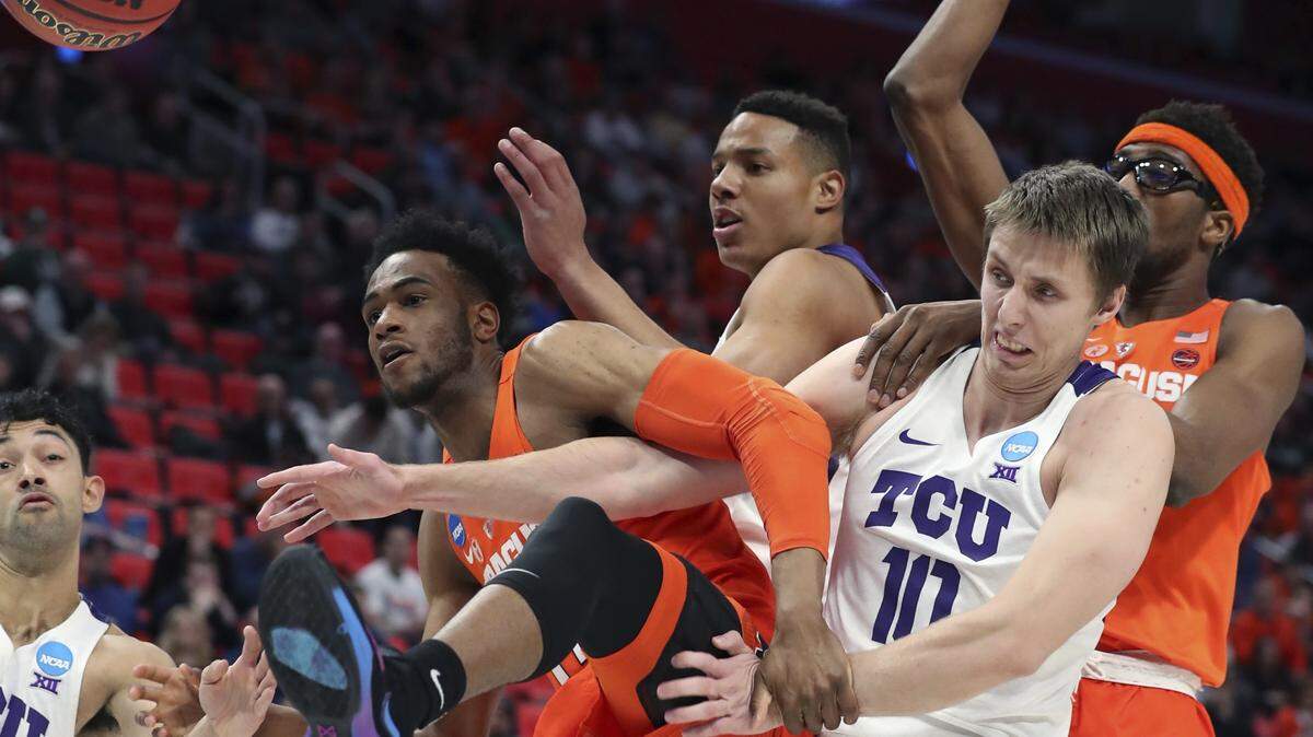 From left-right, Syracuse forward Oshae Brissett, left, TCU guard Desmond Bane, TCU forward Vladimir Brodziansky, and Syracuse center Paschal Chukwu, fight for the rebound during the first half of a first round game in the NCAA college basketball tournament, Friday, March 16, 2018, in Detroit.