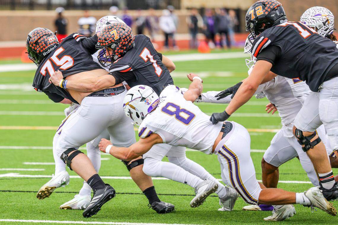 Alvarado’s DJ Clampitt (8) tackles Springtown quarterback Kaine Hill (7) during a Class 4A Division I regional semifinal Friday, Nov. 28, 2025, at Knight Stadium at Eagle Mountain High School in Fort Worth.