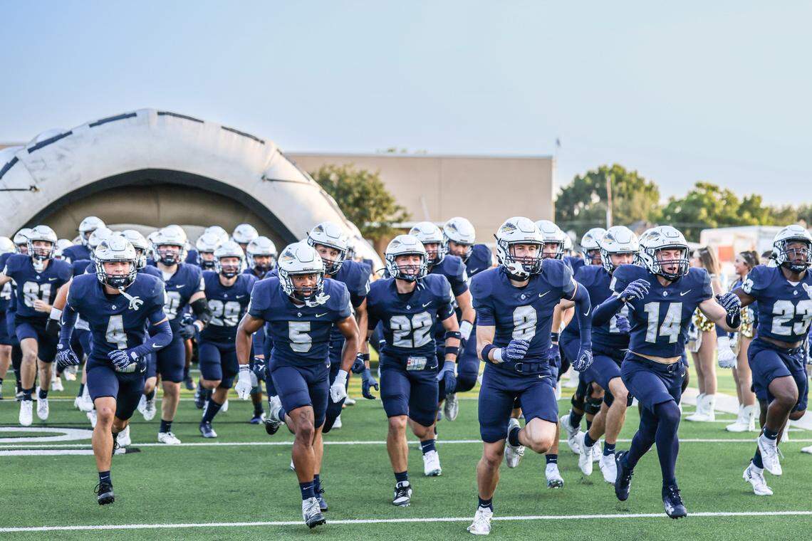 Keller High School’s football team runs onto the field beforn Friday’s District 4-6A game against Northwest High at Keller ISD Stadium. Tom Marvin / Special to the Star-Telegram