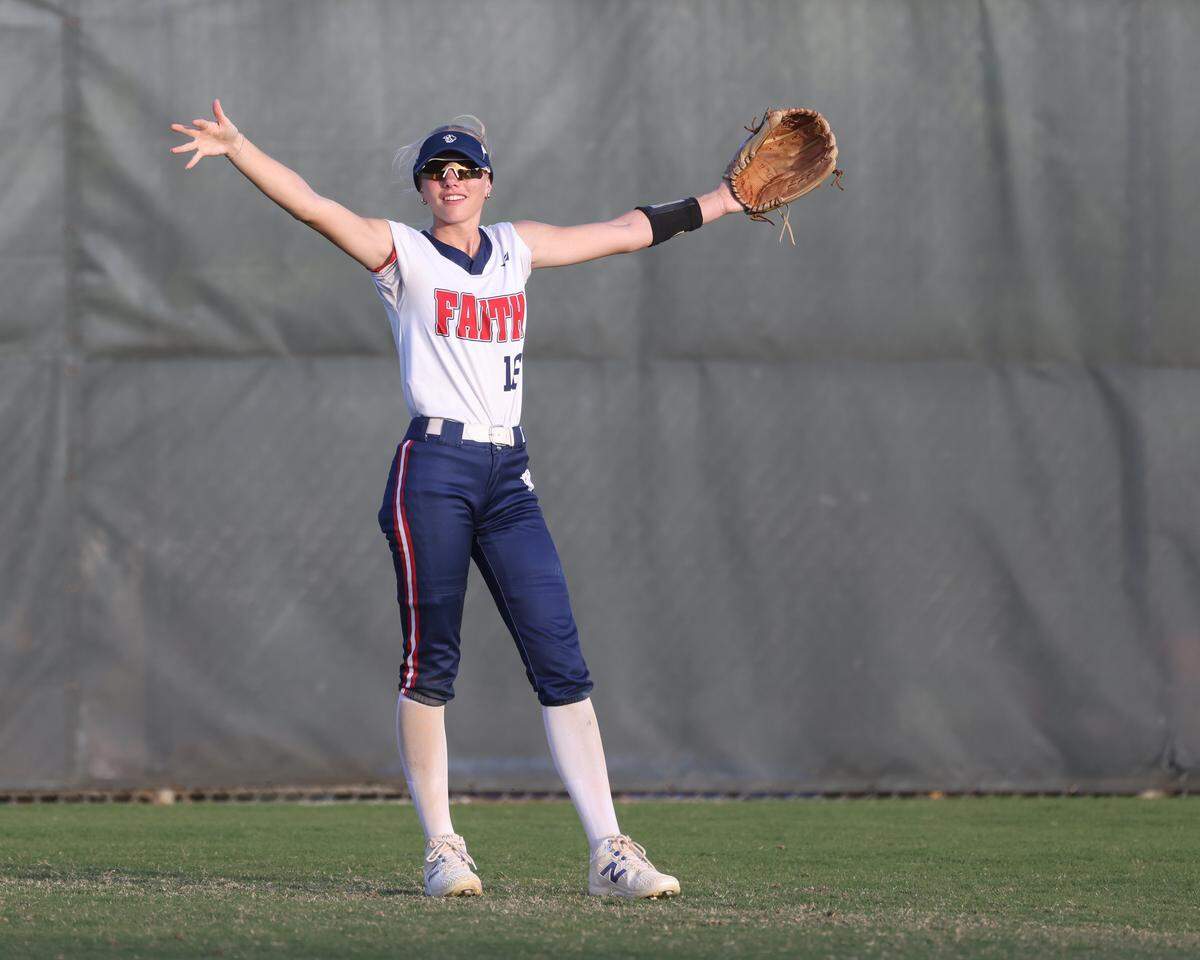 Grapevine Faith center fielder Michaela Hamilton clowns around with team mates in the sixth inning of a softball game at Oak Grove Park in Grapevine, Tx. Tuesday, March 31, 2026