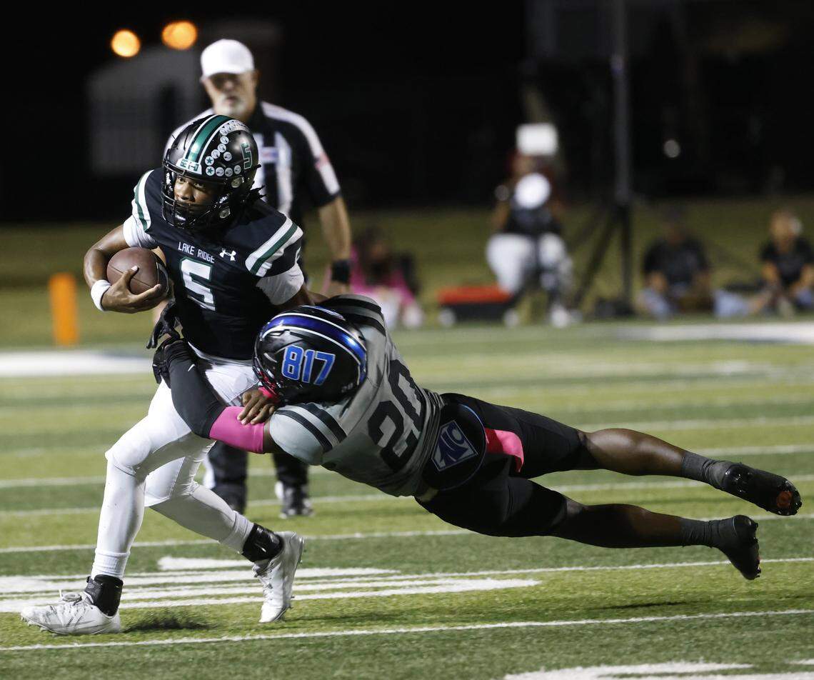 North Crowley linebacker Brock Lacy (20) drops Lake Ridge quarterback DeShawn Edwards (5) in the backfield during the first half of a UIL football game between North Crowley and Lake Ridge at Vernon Newsom Stadium in Mansfield, Texas, Thursday, October 9, 2025.