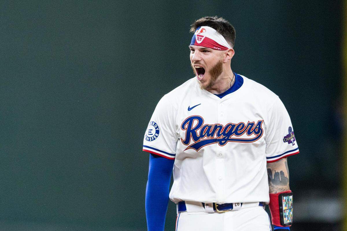 Texas Rangers catcher Jonah Heim (28) celebrates after hitting a walk off single at the bottom of the tenth inning to win their season opener against the Chicago Cubs 4-3 at Globe Life Field in Arlington on Thursday, March 28, 2024.