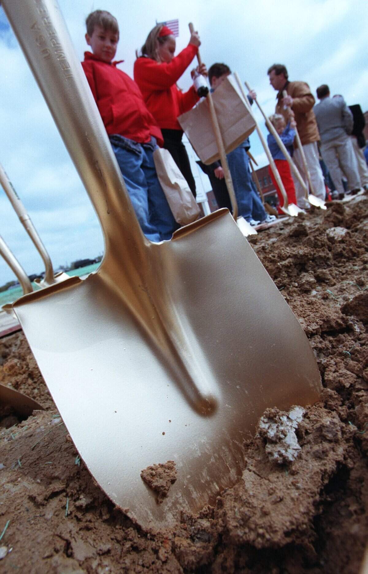 March 20, 1999: Kids and adults stand around talking and trying out the shovels after the ground was officially broken for Southlake's Town Hall, which will be in the center of Town Square.