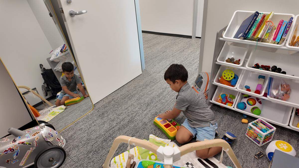 Case, 3, plays with a toy in a children’s play space and nursery room at Varghese Summersett law firm in downtown Fort Worth on Oct. 15, 2025.