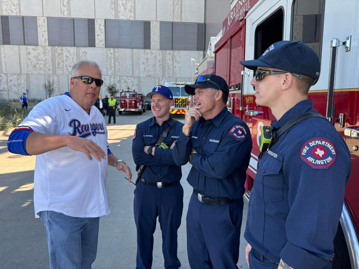 Arlington Mayor Jim Ross talked before the parade with firefighters Zach waters, Mike Joiner and Drew Hanson.