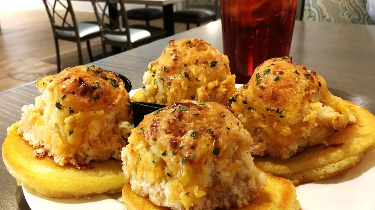 Complimentary biscuits atop hoecakes are brought to the table before the meal at Paula Deen's Family Kitchen in Fairview.