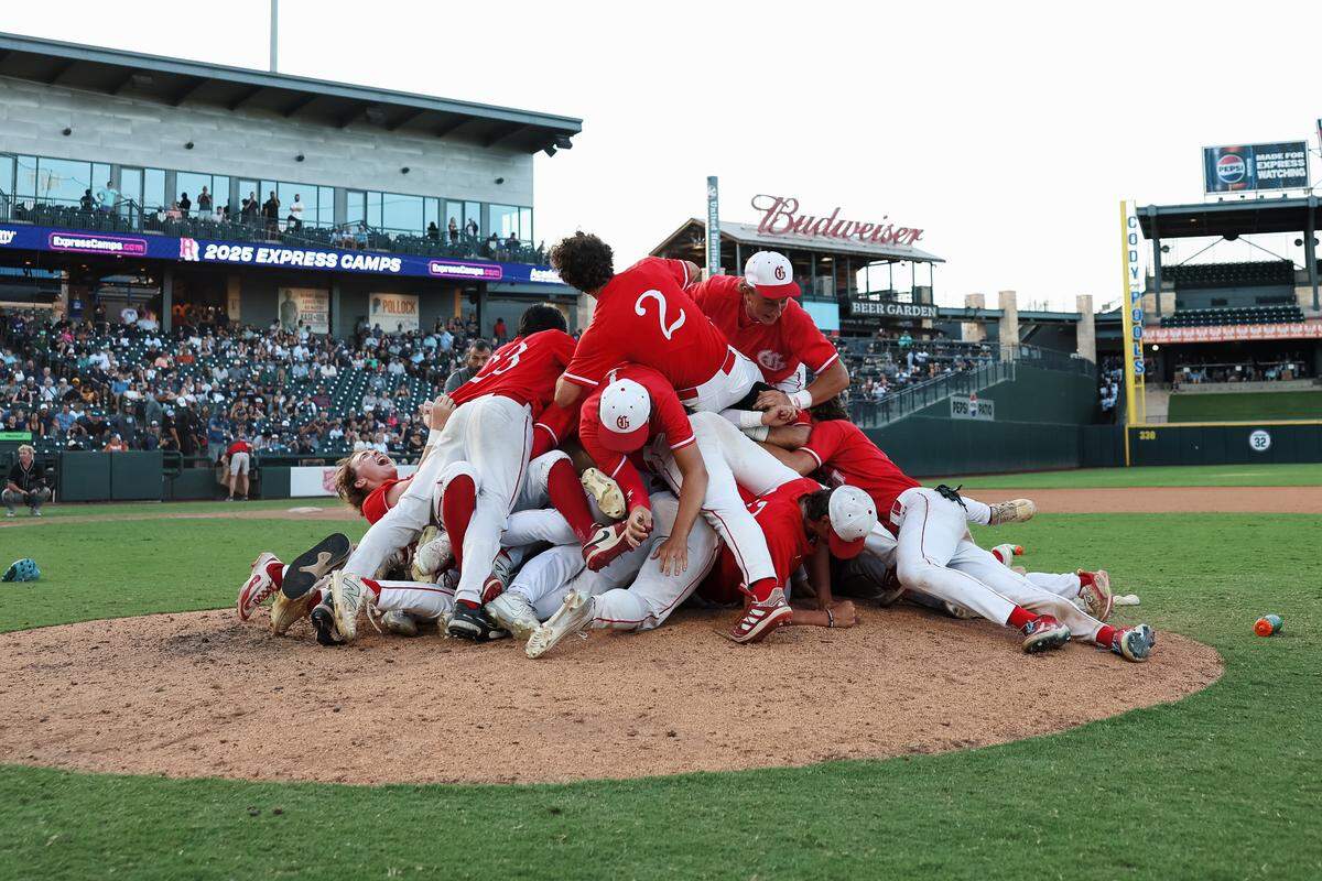Grapevine players jump into a pile on top of the pitchers mound after defeating Kingwood Park 9-5 in the Class 5A Division II state championship game on Friday, June 6, 2025 at Dell Diamond in Round Rock, Texas.