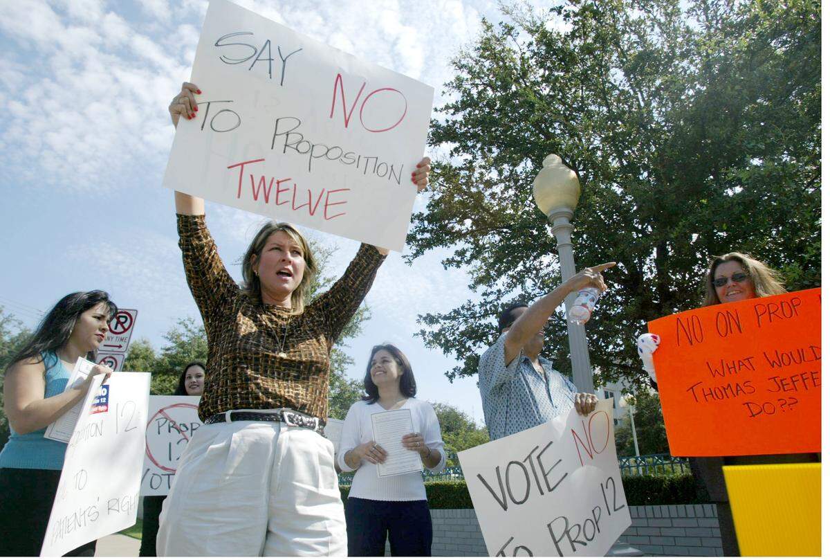 Aug. 28, 2003: Angela Braymer of Grandview, center, holds up a sign opposing Proposition 12 with a small group of protesters outside Cook Children's Hospital in Fort Worth. Anita Perry, wife of Gov. Rick Perry, spoke in favor of Proposition 12 in the atrium of Cooks Hospital. In a special election on Sept. 13, 2003, Texas voters approved the constitutional amendment to limit certain damages in lawsuits against doctors.