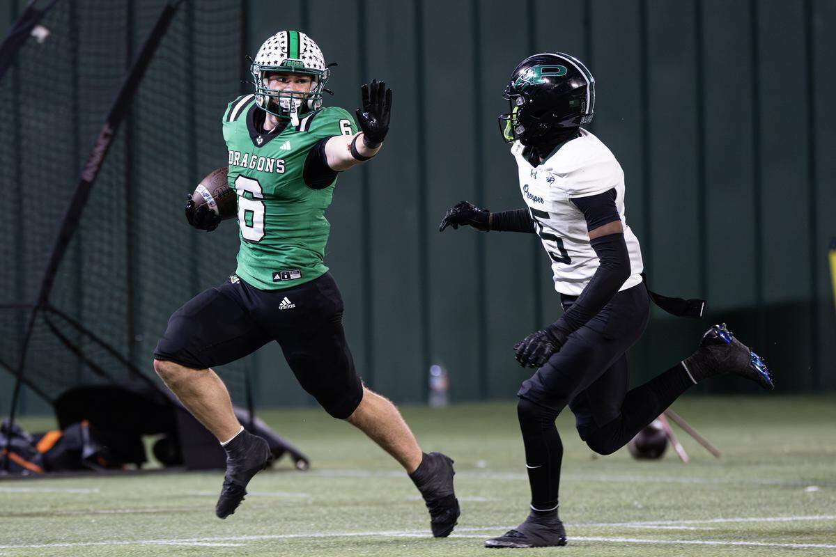 Southlake Carroll defensive back Parker Harris (6) stiff arms a defender for a rushing touchdown in the second half of the UIL Division II Regional playoff game at Choctaw Stadium in Arlington on Friday, Nov. 28, 2025.