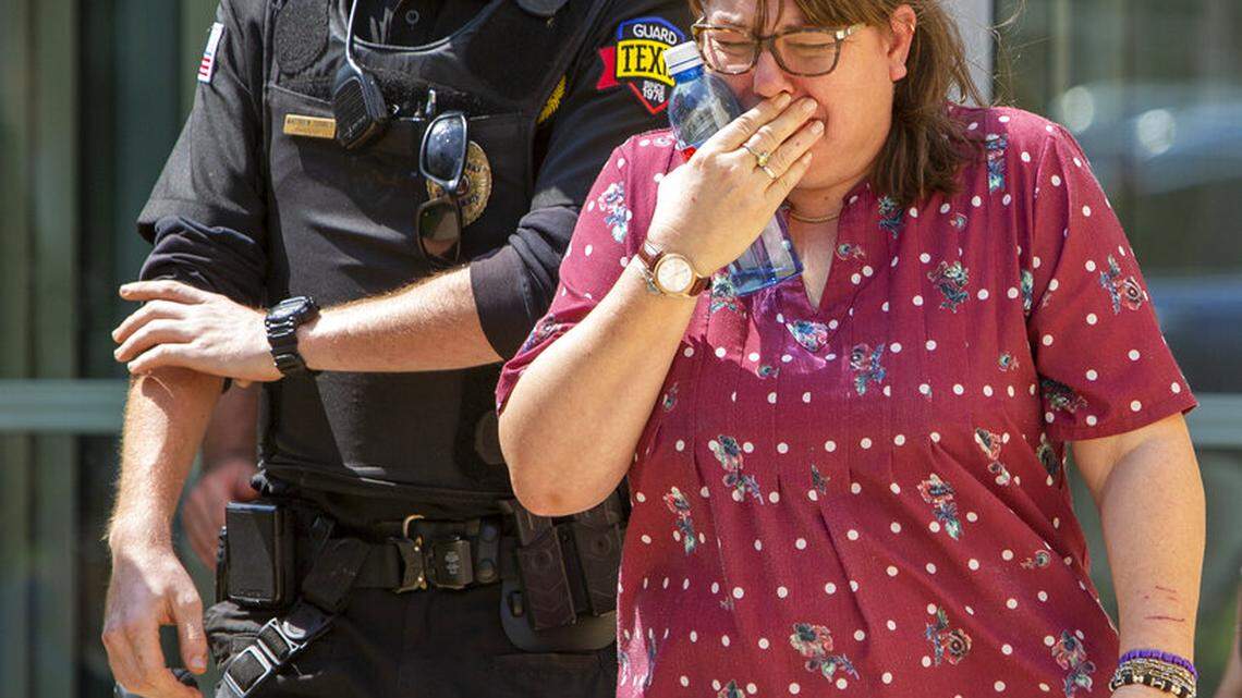 A woman cries as she leave the Uvalde Civic Center following a shooting earlier in the day at Robb Elementary School, Tuesday, May 24, 2022, in Uvalde, Texas. (William Luther/The San Antonio Express-News via AP)