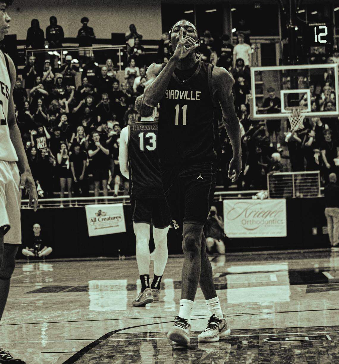 Birdville’s D.J. Driver hushes the Frisco Heritage student section after making a 3-point basket in a Class 5A Division I state semifinal on Tuesday at Hebron.