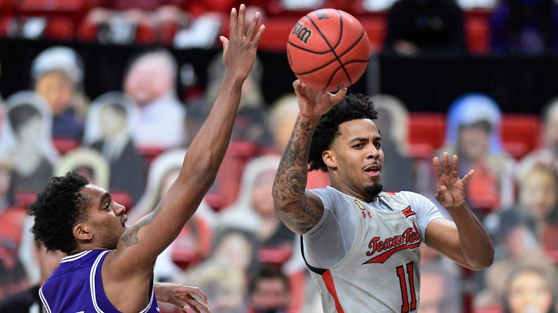 Texas Tech’s Kyler Edwards, right, passes the ball during Tuesday night’s game against TCU in Lubbock. Edwards, who started his high school career at Arlington Bowie, scored a game-high 20 points in the Red Raiders’ victory.