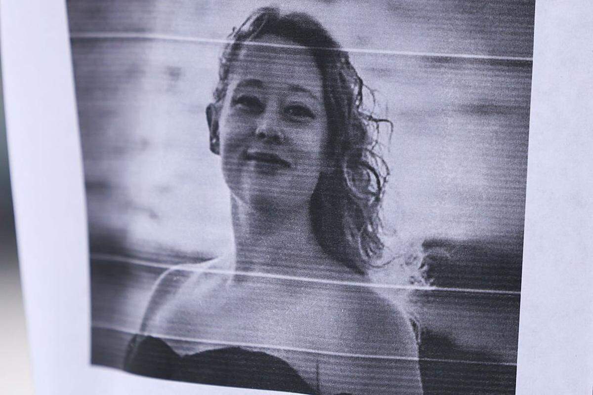 A picture of Renee Nicole Good is displayed near a makeshift memorial for Good, who was shot and killed at point blank range on January 7 by a US Immigration and Customs Enforcement (ICE) agent as she apparently tried to drive away from agents who were crowding around her car, in Minneapolis, Minnesota, on January 8, 2026. A US Immigration and Customs Enforcement (ICE) agent shot and killed an American woman on the streets of Minneapolis January 7, leading to huge protests and outrage from local leaders who rejected White House claims she was a domestic terrorist. (Photo by CHARLY TRIBALLEAU / AFP via Getty Images)