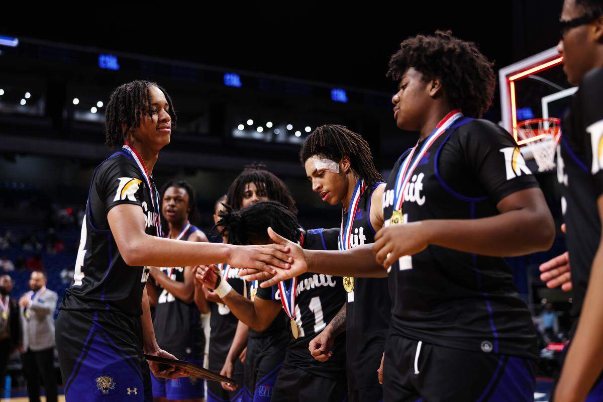 Mansfield Summit guard Joseph Creal III (left) high-fives his teammates after receiving the championship game Most Valuable Player award after the Class 5A Division II state championship game against Beaumont United on Saturday at the Alamodome in San Antonio.