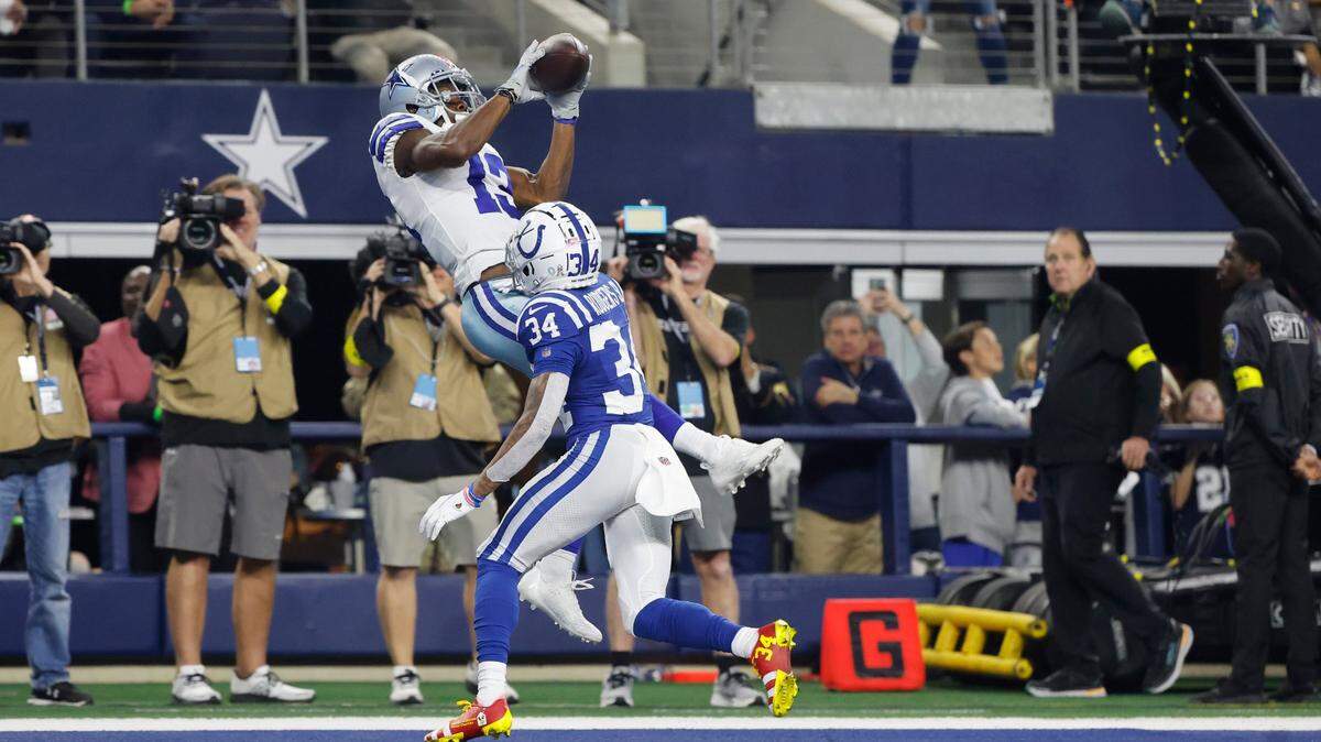 Dallas Cowboys’ Michael Gallup (13) makes a touchdown catch against Indianapolis Colts’ Isaiah Rodgers on Sunday night at AT&T Stadium.