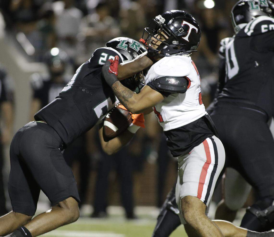Mansfield Lake Ridge running back Jaiden Cotton, left, is stopped by Euless Trinity’s Elijah Smith during their Class 6A Division I bi-district game on Friday, November 14, 2025 at Newsom Stadium in Mansfield Texas.