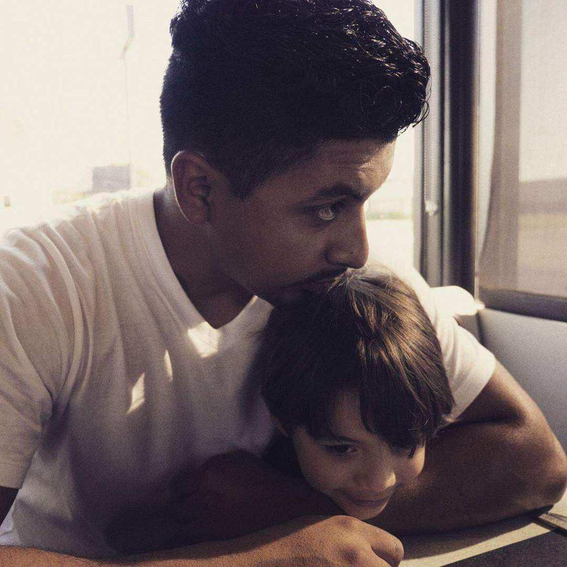 Carlos Delgadillo (left) shares a tender moment with his son in this provided photo. Fort Worth police believe his brother, Ricardo Delgadillo, intentionally shot him to death in early November and then lied to officers by saying it was an accident.