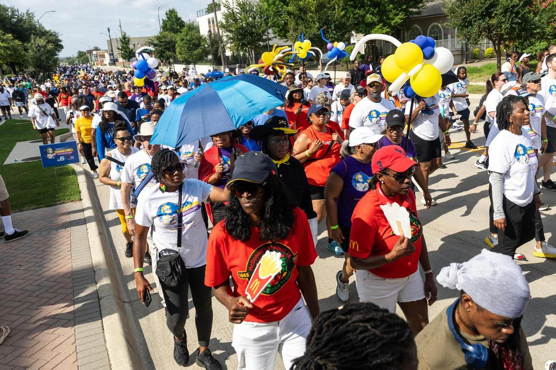 Walk participants walk down Montgomery Street for the Opal Lee Walk for Freedom at Farrington Field in Fort Worth on Thursday, June 19, 2025.