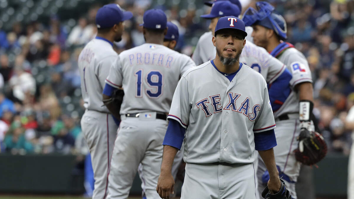 Texas Rangers starting pitcher Yovani Gallardo, right, walks to the dugout after being pulled in the fifth inning of a baseball game against the Seattle Mariners, Sunday, Sept. 30, 2018, in Seattle. The Mariners won 3-1.