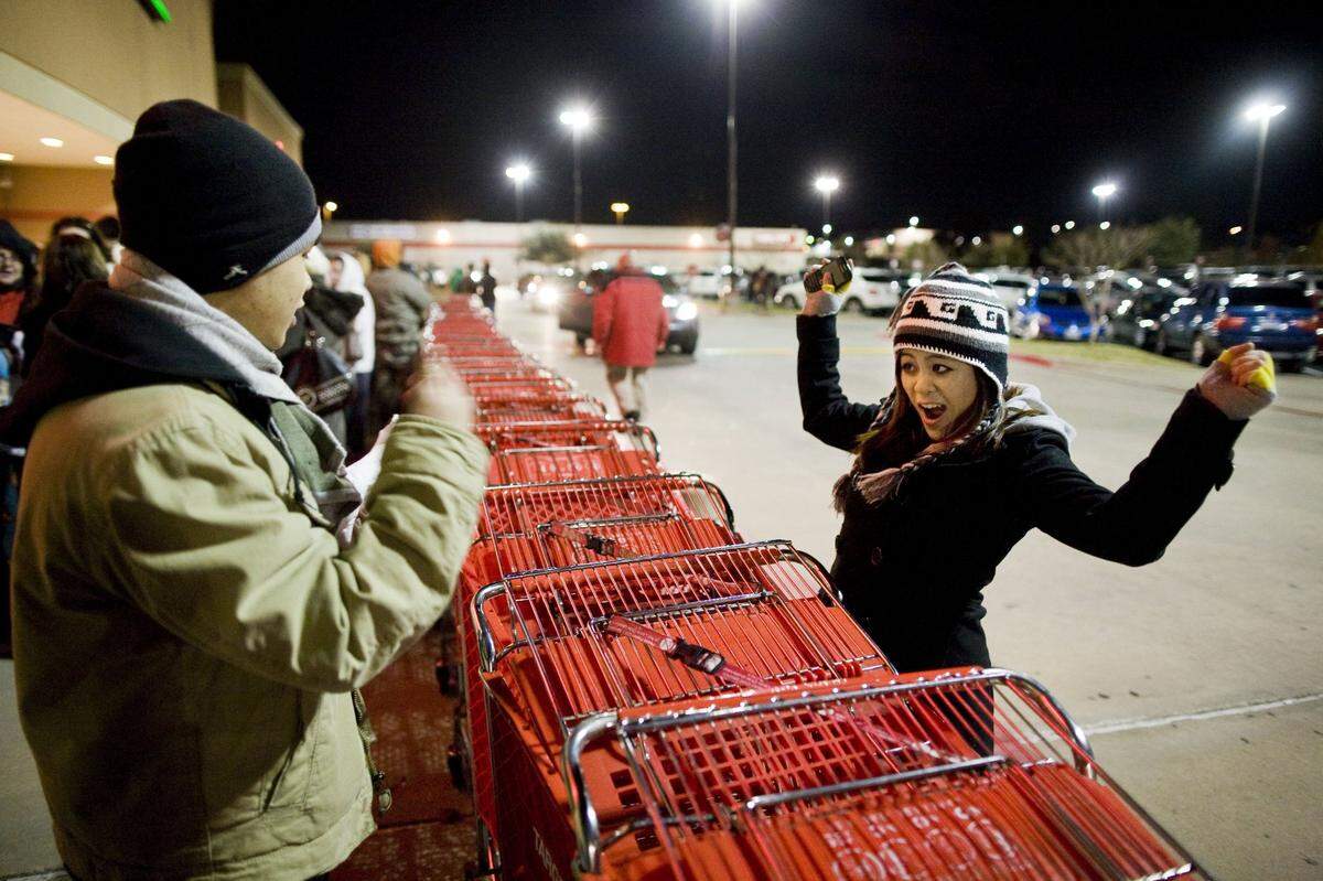 2010: Stephanie Pham, 17, cheers with her brother, Douglas Pham, after he got the last ticket for a 40-inch TV at Target in Hurst, which opened at 4 a.m. on Black Friday.