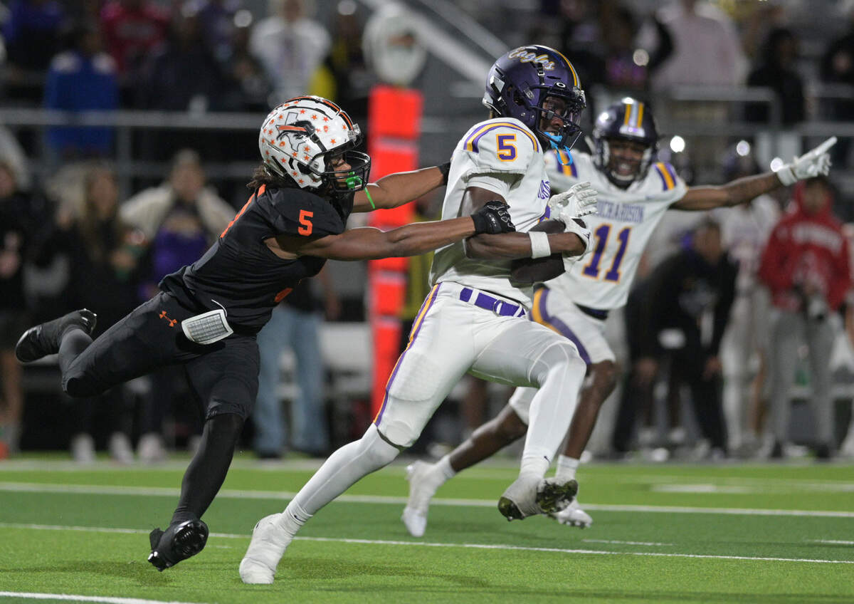 Richardson Eagle defensive back Seyram Tamakloe (5) returns an interception as Haltom running back Vudrico Roberson attempts a tackle during a UIL bi-district playoff football game at Birdville ISD FA/AC in North Richland Hills, Texas on Friday, Nov. 15, 2024.