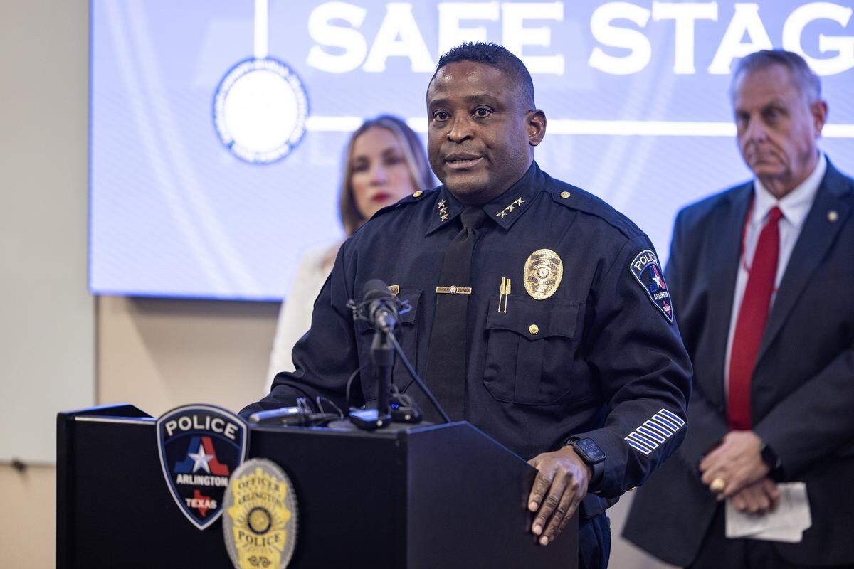 Alexander Jones, the Arlington Chief of Police, along with other law enforcement personnel and community members speak to the media regarding a recent joint operation that resulted in multiple arrests and the disruption of an organized sex trafficking ring in Chicas Locas adult entertainment club at the Arlington Police Department Station on Wednesday, Oct. 29, 2025.