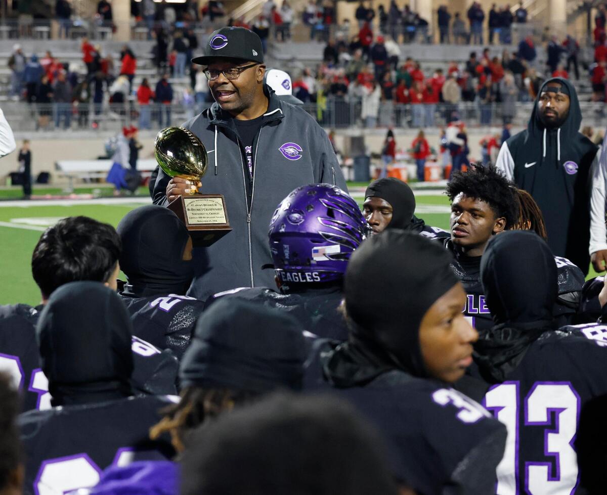 Crowley head coach Carlos Lynn talks to the team after winning the UIL Class 6A D2 Bi-district playoff football game at Crowley ISD Multi-Purpose Stadium in Fort Worth, Texas, Friday, Nov. 15, 2024.