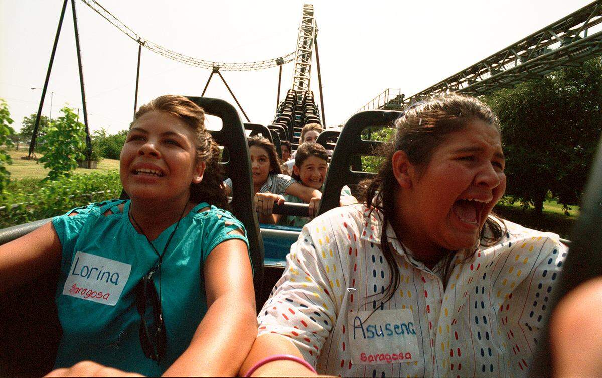 July 31, 1987: Children from Saragosa, Texas, at Six Flags Over Texas. Lorina Garcia and Asusena Melendez ride the Shock Wave.