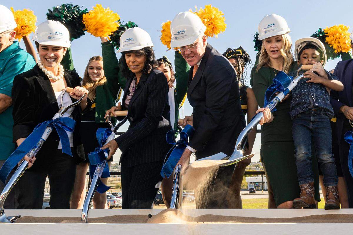 Paige Charbonnet, the Executive Director of the nonprofit LVTRise, Karen Duncan, the President of the JPS Health Network, Rick Merrill, the President of Cook Children’s Health Care System, and Mattie Parker, the Mayor of the City of Fort Worth, while she holds Western Hills Pre-K student Darius Cotter, 4, join in participating in the groundbreaking ceremony for the Las Vegas Trail Neighborhood Health Center in Fort Worth on Tuesday, Nov. 14, 2023.
