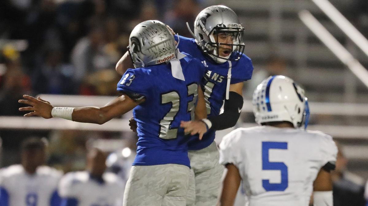 Burleson Centennial defensive back Matiron Easley (23) celebrates with defensive back Da’quan Campbell (21) after Campbell intercepted Corsicana quarterback Jervontae Anderson (2) to end their final drive in the second half of Friday’s playoff game. in Burleson. Centennial defeated Corsicana 28-20.