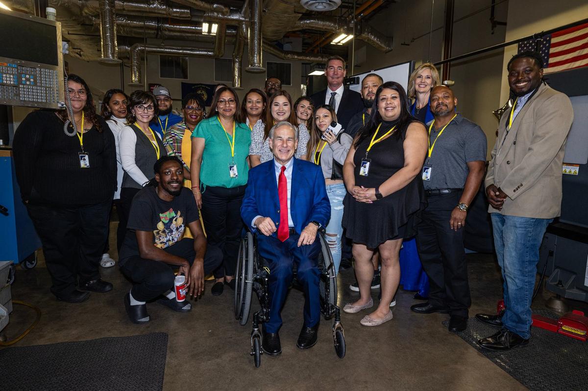 Texas State Governor Greg Abbott takes a photo with students and faculty prior to the grand opening ceremony of the New Heights Adult High School at the Tarrant County College Opportunity Campus in Fort Worth on Wednesday, Sept. 25, 2024. New Heights is the first dual enrollment adult high school in Texas.