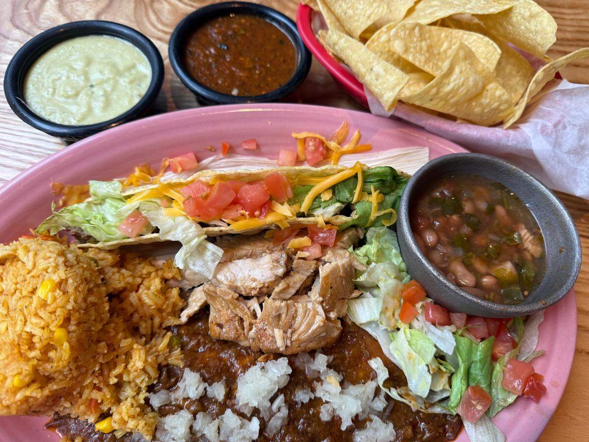 A Las Vegas Combo with chicken fajitas, a cheese-and-chili con carne enchilada and a crispy taco, rice and beans at El Tiempo Cantina, under the first base corner of Choctaw Stadium across from Globe Life Field, as seen March 31, 2025.