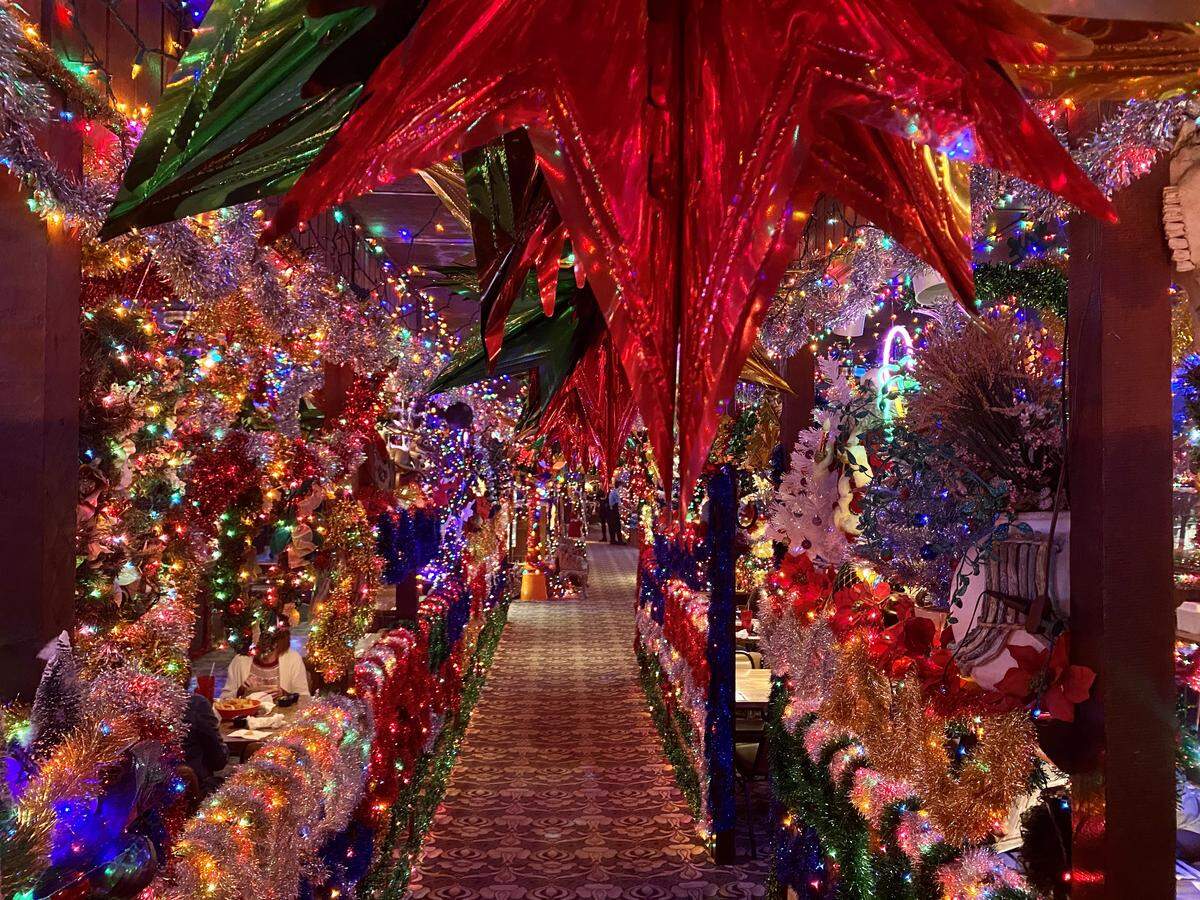 A hallway at Campo Verde decorated with 200,000 lights and a toy train that circles the dining room.